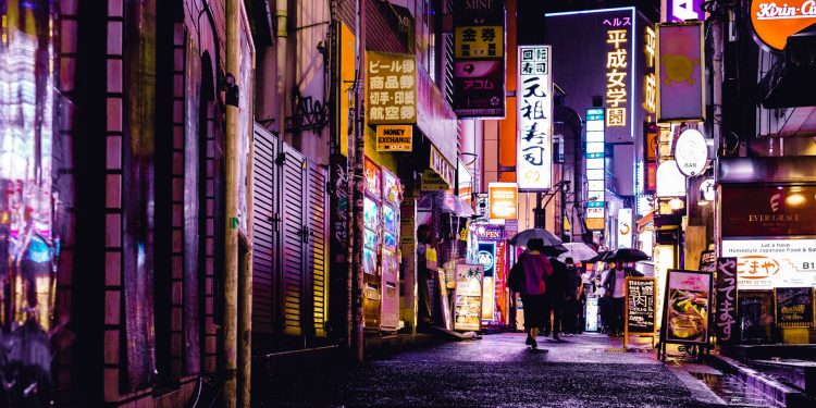 woman walking in the street during night time