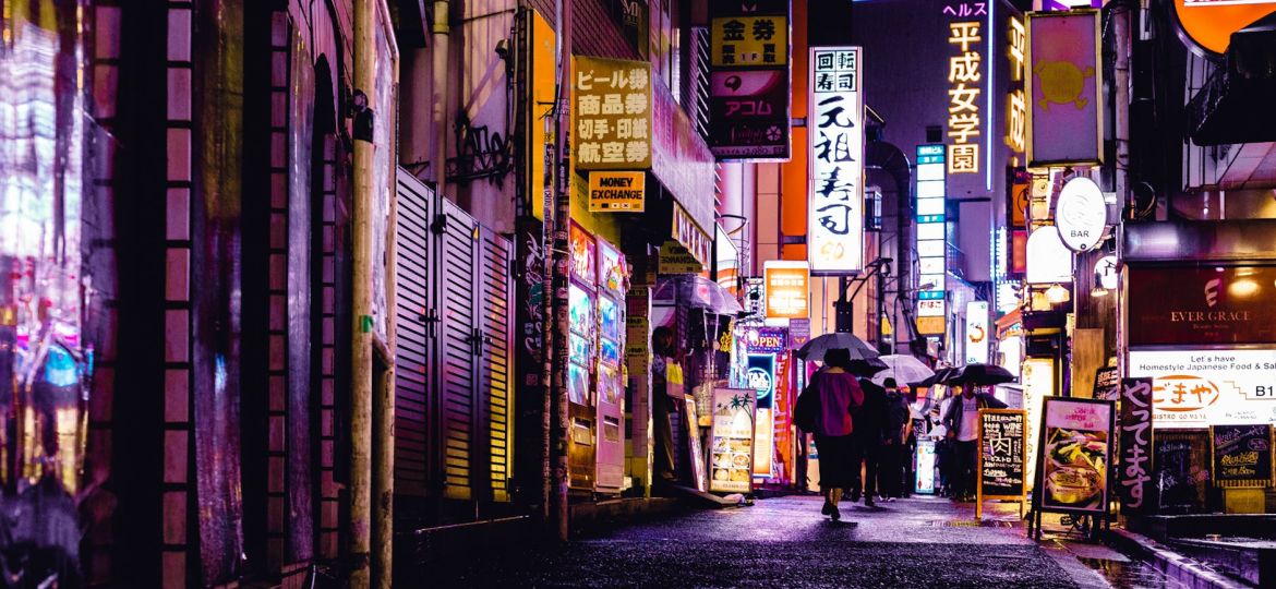 woman walking in the street during night time