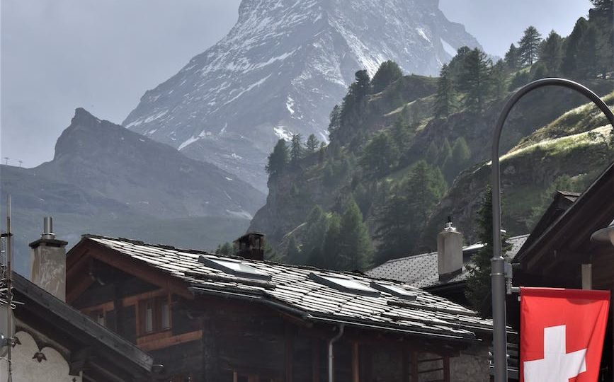 rocky mountain under cloudy sky