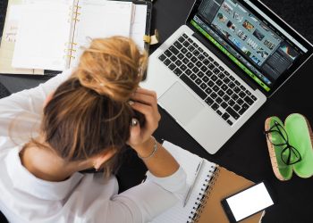 woman sitting in front of macbook