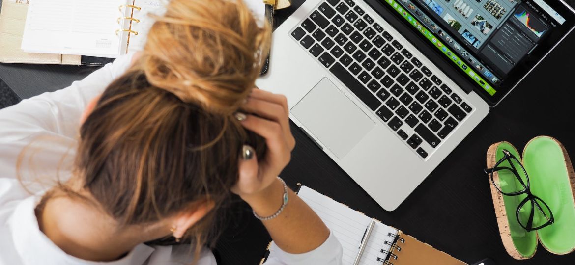 woman sitting in front of macbook