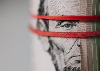 roll of american dollar banknotes tightened with band