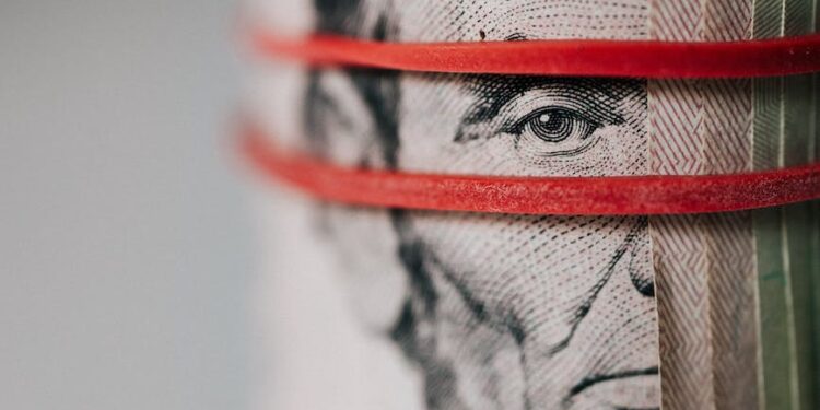 roll of american dollar banknotes tightened with band