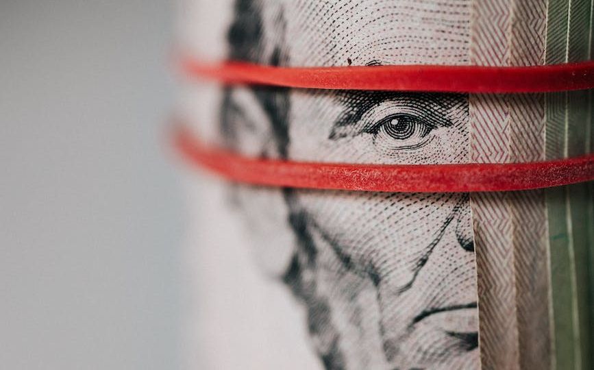 roll of american dollar banknotes tightened with band