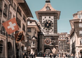 photo of people near clock tower during daytime
