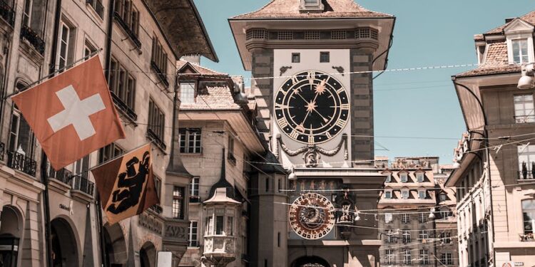 photo of people near clock tower during daytime