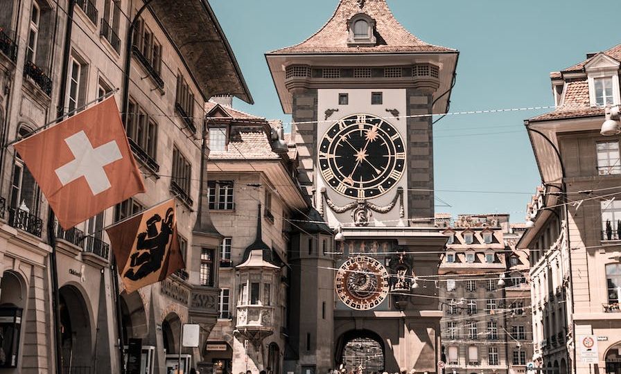 photo of people near clock tower during daytime