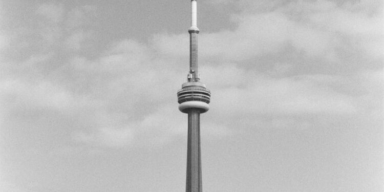 grayscale photo of tower and buildings