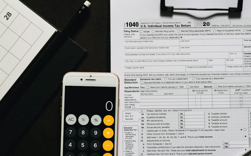 calculator smartphone on a clipboard with white paper