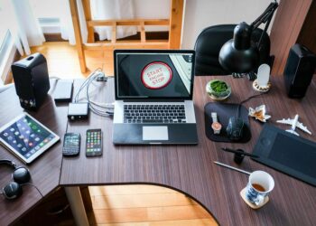 black and white laptop computer on brown wooden desk