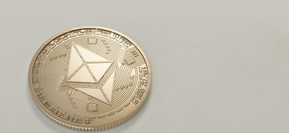 round gold colored ethereum coin